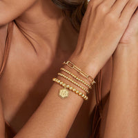 doubgood Gold Beaded Bracelets for Women, Stackable Gold Bracelets for Women Girls 14K Real Gold Plated Stretch Bead Ball Bracelet with Letter Pendant M