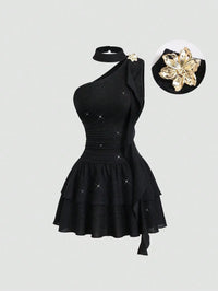 Black Asymmetrical One-Shoulder Dress with Gold Floral Brooch & Tiered Flounce Skirt