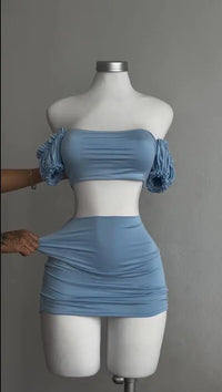 A sexy and fashionable two-piece short skirt with hollowed-out pleated puffed sleeves that wraps the hips