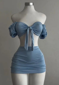 A sexy and fashionable two-piece short skirt with hollowed-out pleated puffed sleeves that wraps the hips